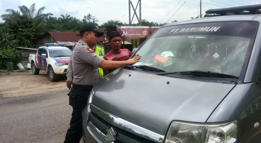 Kapolsek Tapung Hulu Bagikan Stiker Himbauan Keselamatan Berlalulintas