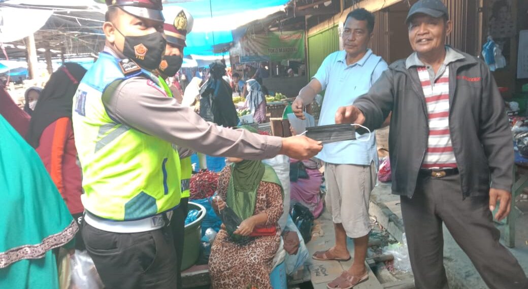 Kasat Lantas Polres Kampar Beri Himbauan Protkes dan Bagi Masker di Pasar Air Tiris